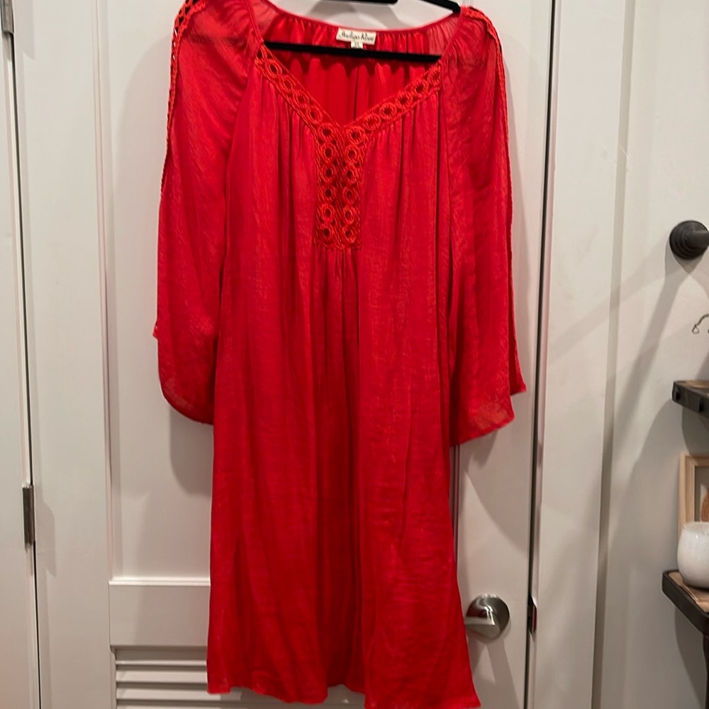 Super cute red knee length dress. Gauzy fabric with a full lining.
